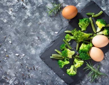 broccoli und eier auf brett dunkelgrauer tisch